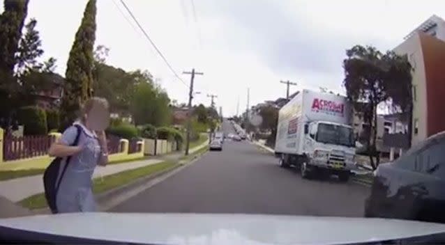 The girl is startled by the close call, when she realises she was almost hit. Picture: YouTube/Jeffrey Cheng