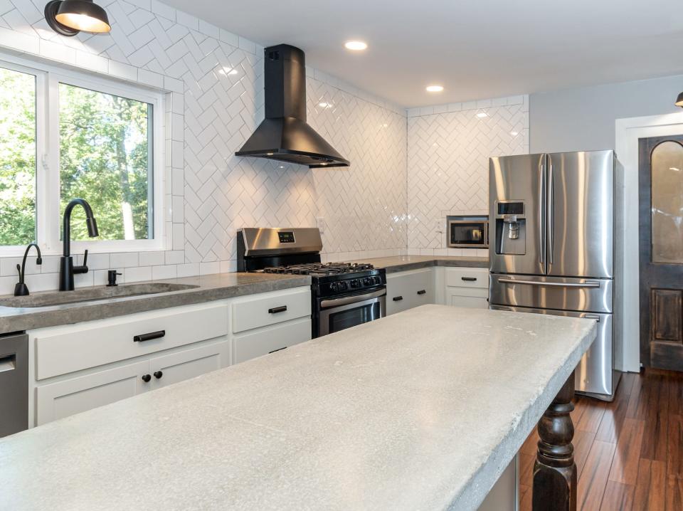 white cabinets and concrete countertops in kitchen