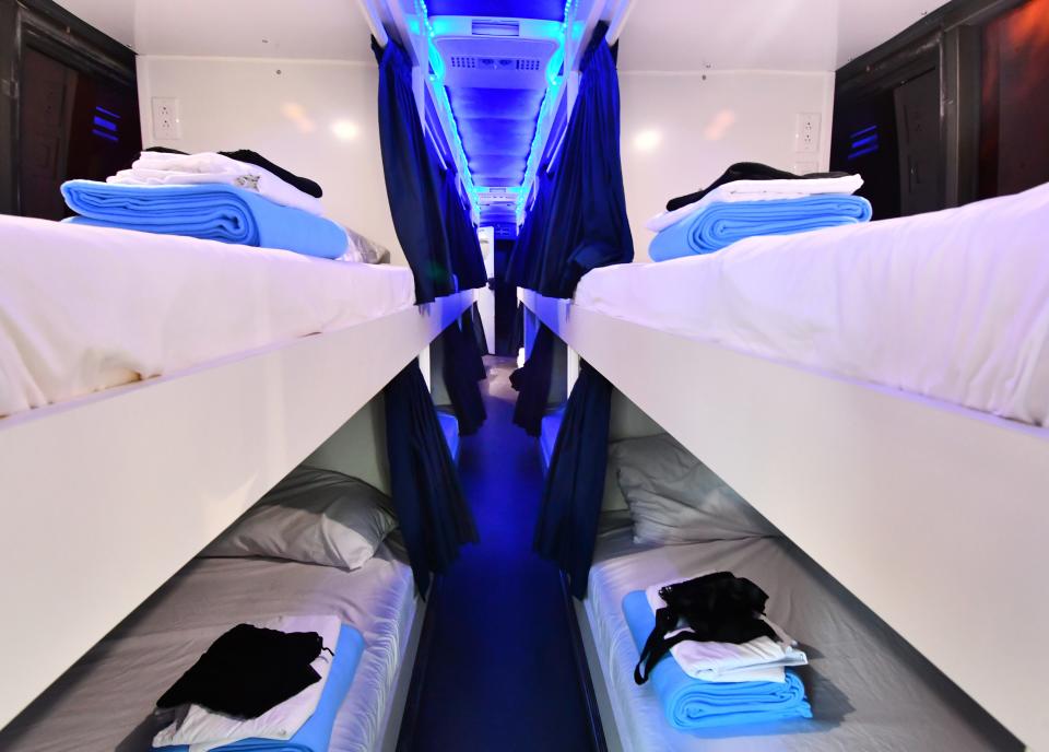 The Dignity Bus features 16 sleep pods outfitted with privacy curtains, lights and electrical outlets.