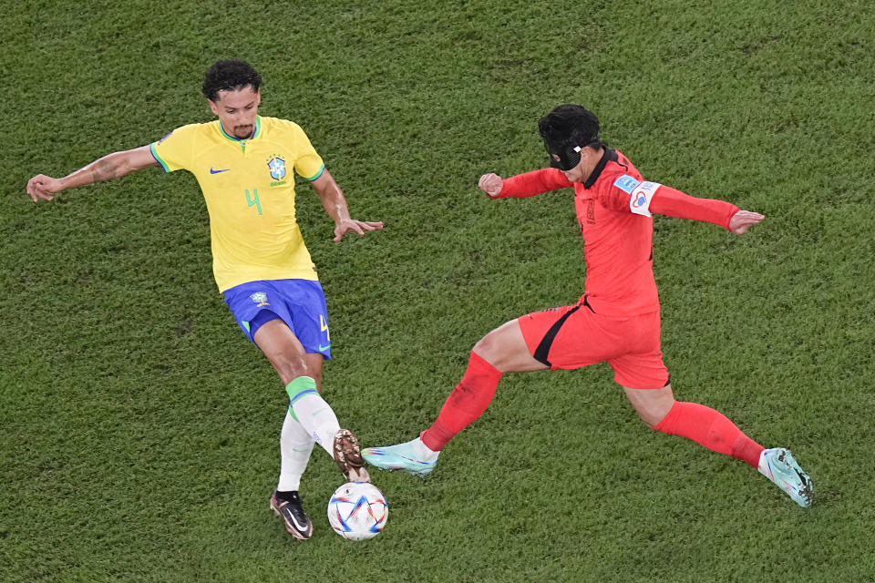 South Korea's Son Heung-min, right, and Brazil's Marquinhos vie for the ball during the World Cup round of 16 soccer match between Brazil and South Korea, at the Education City Stadium in Al Rayyan, Qatar, Monday, Dec. 5, 2022. (AP Photo/Pavel Golovkin)