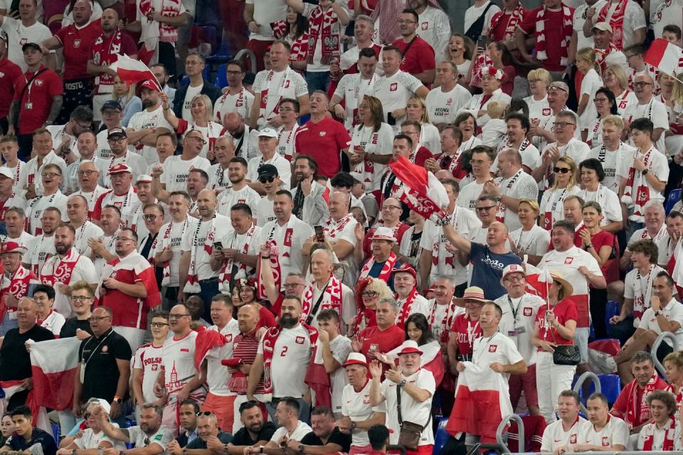 Fans of the team from Poland cheer during the World Cup group C football match between Mexico and Poland, at the Stadium 974 in Doha, Qatar, Tuesday, Nov. 22, 2022. (AP Photo/Themba Hadebe)