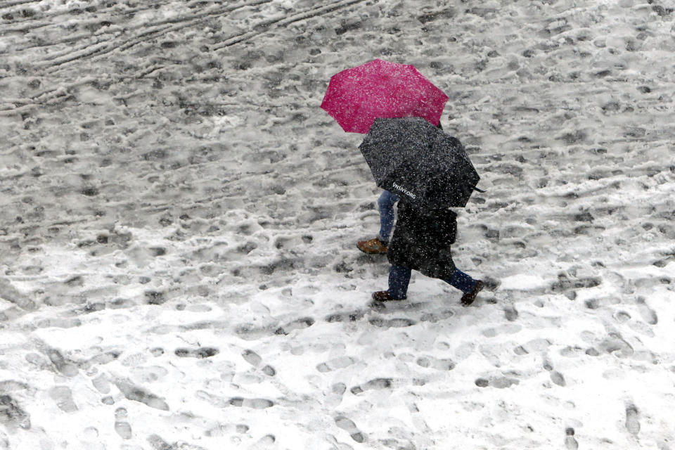 Pedestrians make prints in the snow and slush as they pass through Union Square Monday, Feb. 3, 2014, in New York. Another winter storm bears down on the eastern U.S., only a day after temperatures soared into the 50s. (AP Photo/Jason DeCrow) (AP Photo/Jason DeCrow)