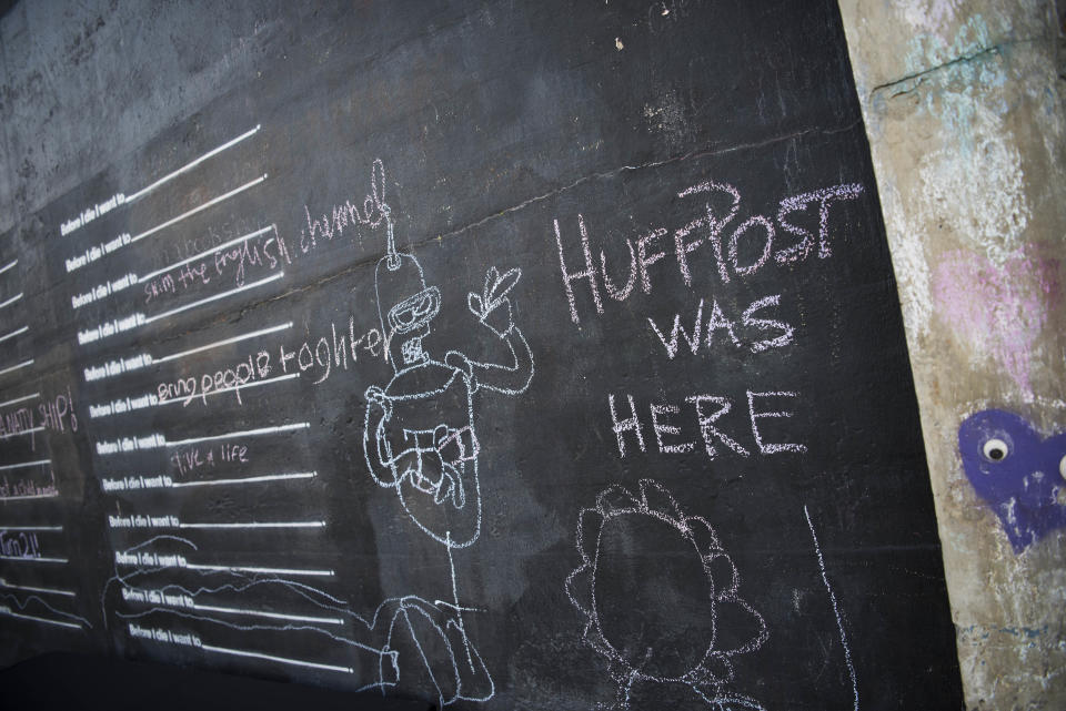 "HuffPost was here" is written in chalk on a wall in IX Art Park.