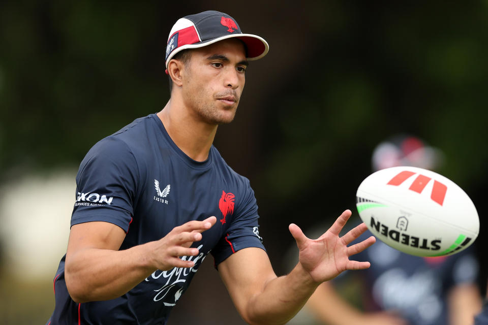 Joseph Suaalii takes a pass during a Sydney Roosters NRL training session.