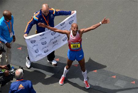 Apr 21, 2014; Boston, MA, USA; Meb Keflezighi of the United States celebrates after winning the 2014 Boston Marathon. Greg M. Cooper-USA TODAY Sports