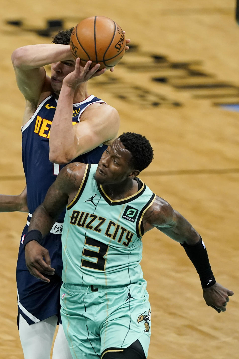 Denver Nuggets forward Michael Porter Jr. is fouled by Charlotte Hornets guard Terry Rozier during the first half of an NBA basketball game on Tuesday, May 11, 2021, in Charlotte, N.C. (AP Photo/Chris Carlson)