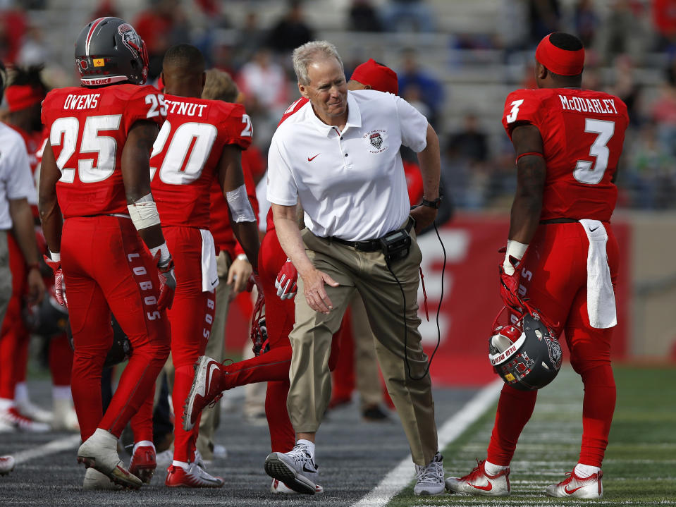 New Mexico coach Bob Davie after speaking to running back Richard McQuarley (3) during the first half of an NCAA college football game against Utah State in Albuquerque, N.M., Saturday, Nov. 4, 2017. (AP Photo/Andres Leighton)