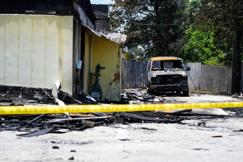 Police investigators work the scene of what remains of the Vero Beach Laundry & Cleaners and Kidz Closet of Vero Beach on Wednesday, May 18, 2022. Both businesses were destroyed in an overnight fire that was reported at 9:15 p.m. Tuesday. A State Fire Marshal investigation is underway to determine the cause.