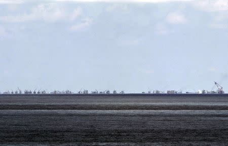 FILE PHOTO - The alleged on-going land reclamation of China at Subi reef is seen from Pagasa island (Thitu Island) in the Spratlys group of islands in the South China Sea, west of Palawan, Philippines, May 11, 2015. REUTERS/Ritchie B. Tongo/Pool/File Photo