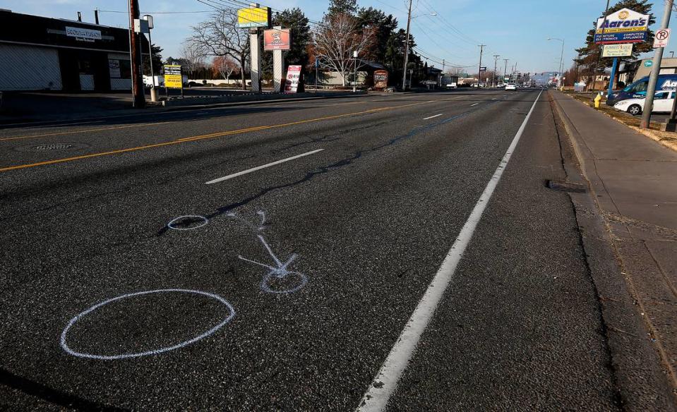 Police investigative paint markings indicate where a 28-year-old woman was hit Sunday night in the middle of Clearwater Avenue in Kennewick. Police are searching for the driver who seriously injured the pedestrian in the westbound lanes in the 5000 block of the five lane roadway.