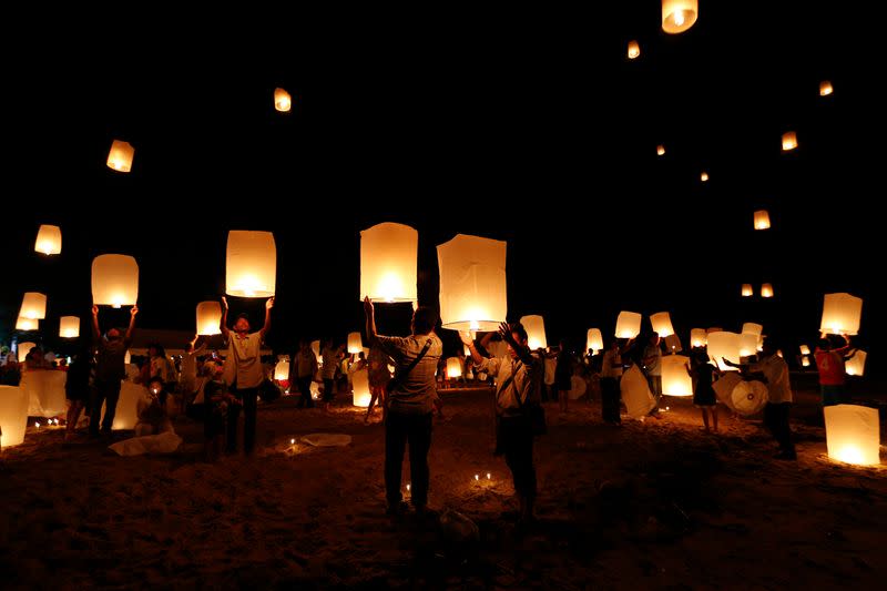 Survivors, local residents and visitors release paper lanterns during the ceremony for victims of 2004 tsunami in Ban Nam Khem, a southern fishing village destroyed by the wave