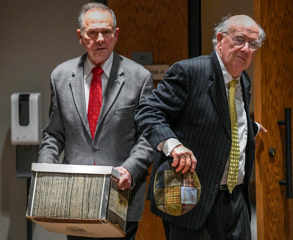 Former Alabama Chief Justice Roy Moore, left, and his attorney Julian McPhillips leave the courtroom in the Montgomery County Courthouse in Montgomery, Ala., on Monday January 24, 2022, following jury selection, as the trial with Leigh Corfman, who accused former Moore of sexual assault, and Moore’s defamation lawsuits against each other begins.