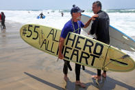 OCEANSIDE, CA - MAY 6: Fred Hodges shows a surfboard he decorated during a "paddle-out" in honor of NFL star Junior Seau on May 6, 2012 in Oceanside, California. Seau, who played for various NFL teams including the San Diego Chargers, Miami Dolphins and New England Patriots was found dead in his home on May 2nd of an apparent suicide. Family members have decided to donate his brain for research on links between concussions and possible depression. (Photo by Sandy Huffaker/Getty Images)