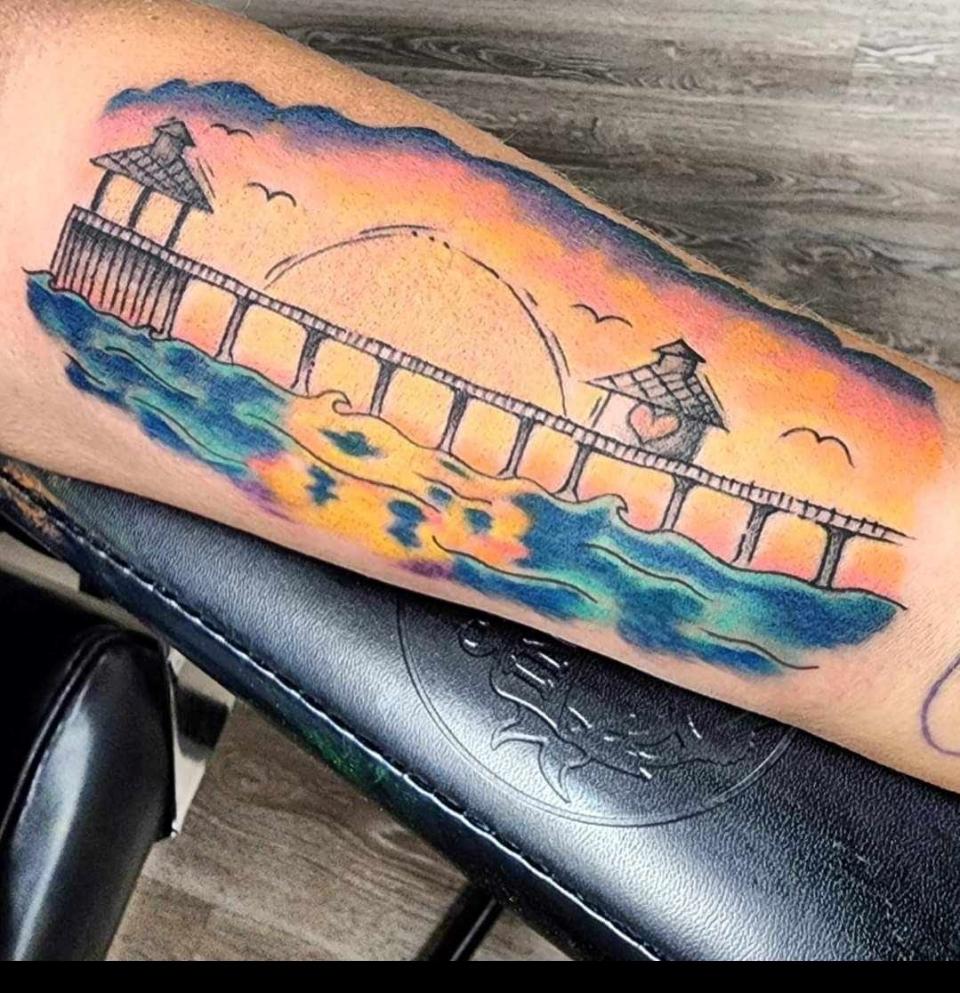 This is the tattoo of the Fort Myers Beach pier on the left arm of Tracy Wilson Deryckere.