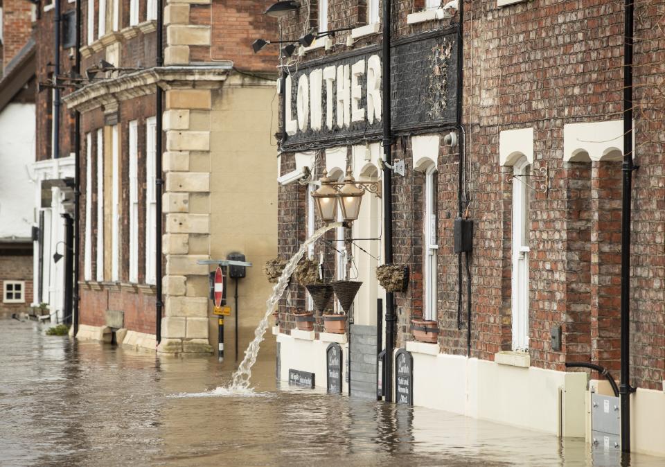 Flooding water is pumped from the Lowther pub in York after the River Ouse burst its banks, as a third consecutive weekend of stormy weather is bringing further flooding misery to already sodden communities.