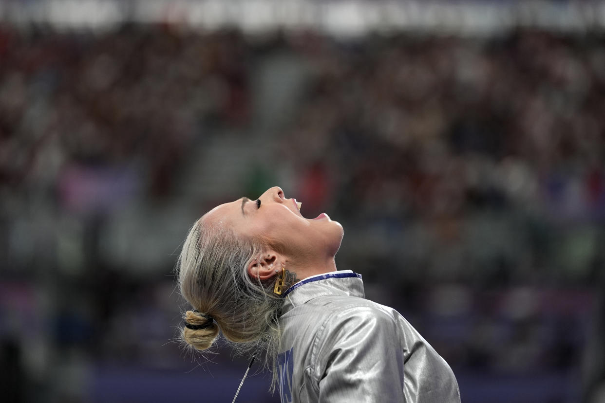 Hungarian fencer Liza Pusztai reacts at the end of the women's individual sabre round of 32 competition against Italy's Michela Battiston.