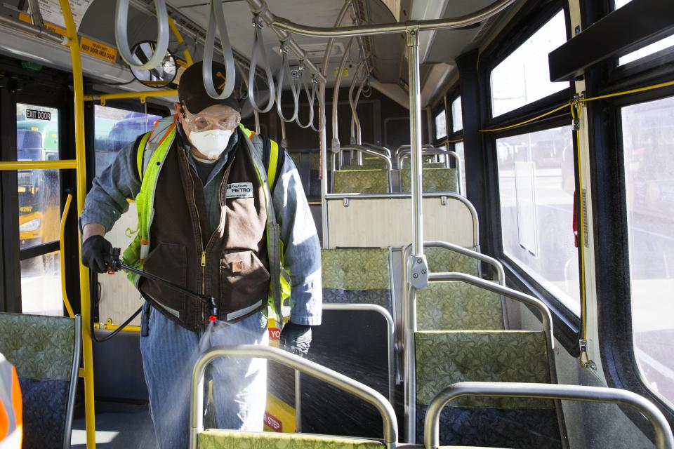 Larry Bowles, an equipment service worker for King County Metro, sprays Virex II 256, a disinfectant, throughout a metro bus at the King County Metro Atlantic/Central operating base in Seattle, Washington. The fleet of 1,600 buses will get sprayed once a day to prevent the spread of the novel coronavirus, COVID-19.