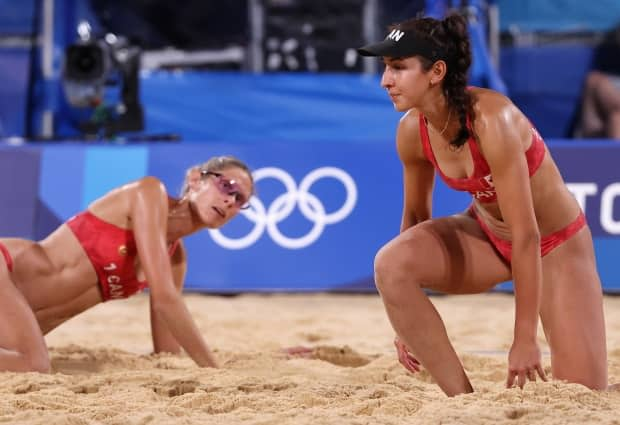 From left to right, Sarah Pavan and Melissa Humana-Paredes of Team Canada react as they compete against Team Australia during their women's quarter-final beach volleyball match on Tuesday in Tokyo's Shiokaze Park. (Sean M. Haffey/Getty Images - image credit)