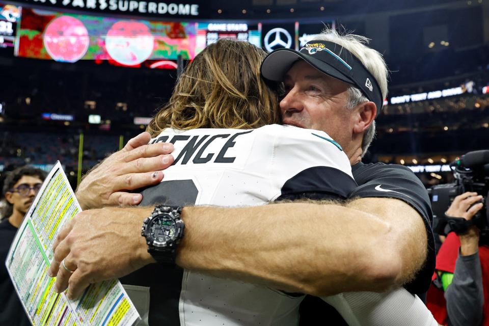 Jacksonville Jaguars quarterback Trevor Lawrence, left, gets a hug from head coach Doug Pederson after defeating the New Orleans Saints in an NFL football game in New Orleans, Thursday, Oct. 19, 2023. (AP Photo/Butch Dill)