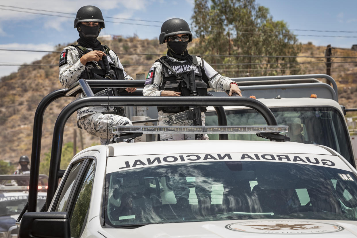 LA PAZ, MEXICO - MAY 11: National Guard officers wearing protective masks support the BCS Community Alliance on a food distribution on May 11, 2020 in La Paz, Mexico. Mexico is on Stage Three of health emergency, as deaths and positive cases grow. According to Health Ministry, Mexico faces the most dangerous week with an exponential spread of contagion. While only essential activities are permitted, government suggests population to stay at home but quarantine is not obligatory as there is major concern about the economic activity. Social distancing measures could be over between May 18 and 30. (Photo by Alfredo Martinez/Getty Images)