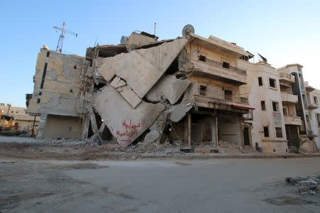 A damaged building is seen in Hraytan city, about 10 kilometers away from the towns of Nubul and Zahraa, Northern Aleppo countryside, Syria February 3, 2016. The text on the building reads in Arabic: "Agricultural pharmacy." REUTERS/Abdalrhman Ismail