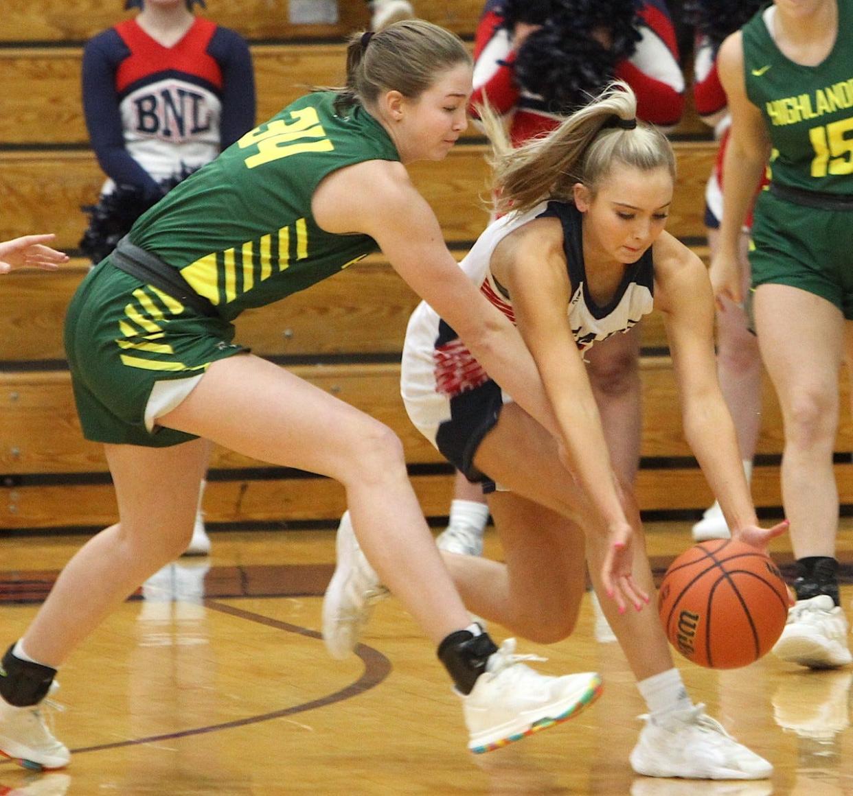 BNL's Chloe Spreen (right) outraces Floyd Central's Nora Gibson to a loose ball Saturday night at BNL Fieldhouse. Spreen had 18 points and 14 rebounds in a 62-28 victory.