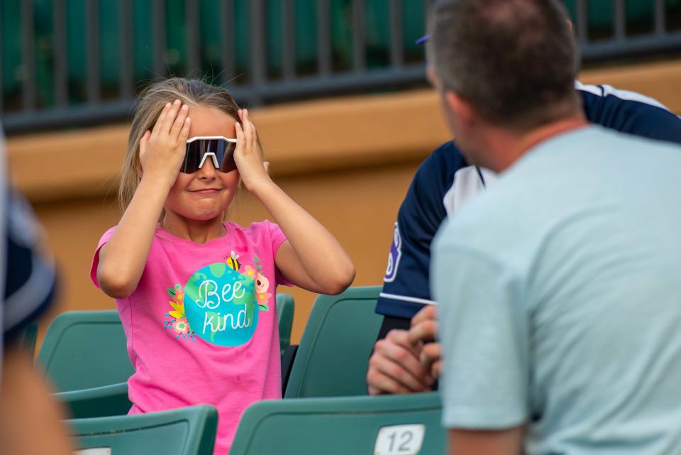 A young fan tries on a player's shades during the Jackson Rockabillys' "Greet the Goats" event inside The Ballpark in Jackson on Tuesday, May 30, 2023. 