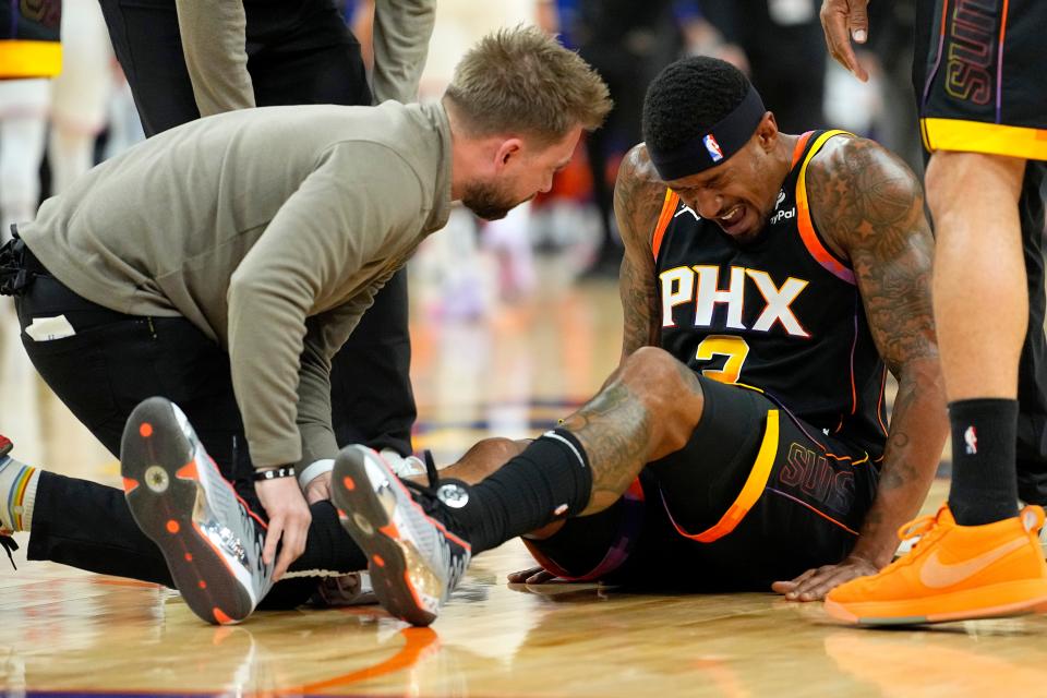 Phoenix Suns guard Bradley Beal (3) sits on the court after an injury against the New York Knicks during the first half of an NBA basketball game, Friday, Dec. 15, 2023, in Phoenix.
