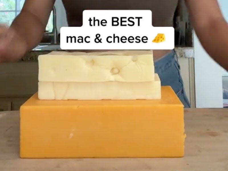 three hard cheeses are stacked on top of one another with the writing "the BEST mac & cheese" written over it