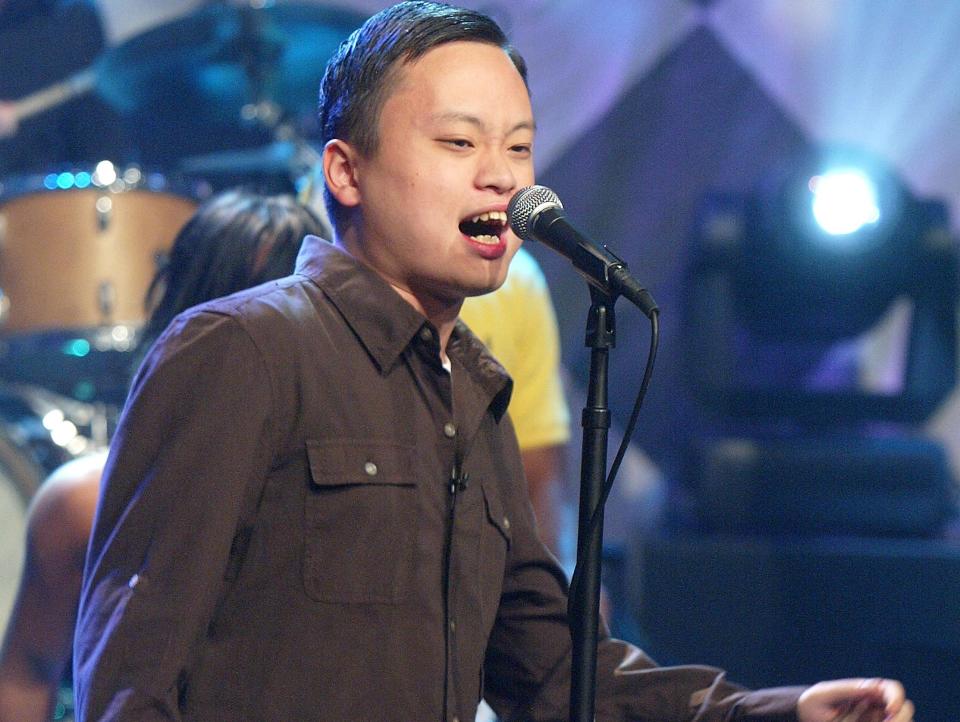 william hung singing into a microphone during a 2004 performance on the tonight show