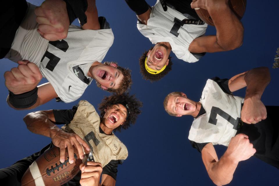 Basha players Jack Bleier (clockwise from left) Miles Lockhart, Tommy Prassas and Demond Williams Jr., at their school's home football field in Chandler on Aug. 14, 2023.