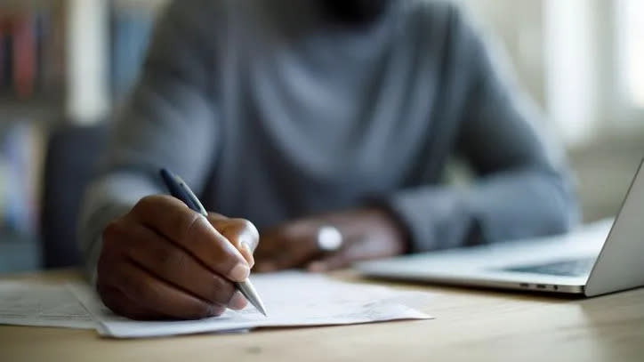 A man signs his estate planning documents.