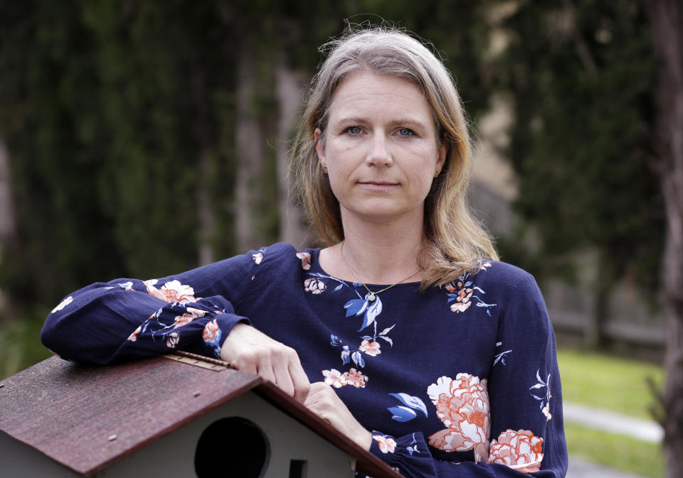 Astrid Magenau poses for a photo at her home in Sydney on Oct. 19, 2020. Magenau wasn’t able to keep a promise to hold her father’s hand at his deathbed in Germany because of Australia’s extraordinary pandemic restrictions that make her feel like a prisoner in her adopted country. (AP Photo/Rick Rycroft)