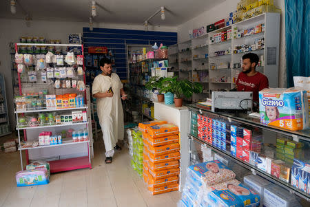 A man buys medicine at a pharmacy after forces loyal to Libyan commander Khalifa Haftar took control of the area, in Derna, Libya June 13, 2018. Picture taken June 13, 2018. REUTERS/Esam Omran Al-Fetori