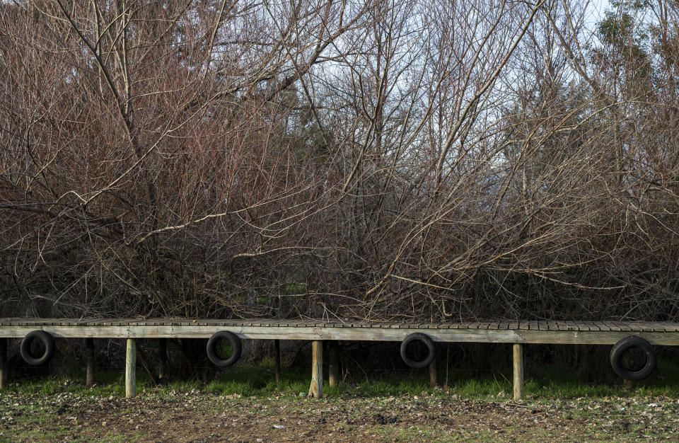 A dock once surrounded by water is seen at an abandoned Aculeo Lagoon resort, in Paine, Chile, Friday, Aug. 23, 2019. Despite having one of the largest fresh water reserves in the world, Chilean authorities declared an agricultural emergency this week as rural areas in the province of Santiago suffer the effects of the worst drought that has hit the area in decades. (AP Photo/Esteban Felix)