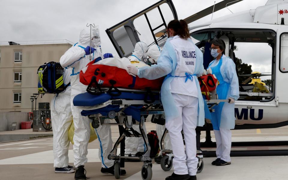 A medical crew tends to a COVID-19 patient after his transfer by helicopter from the Ile de France region to Angers hospital, France, on March 15