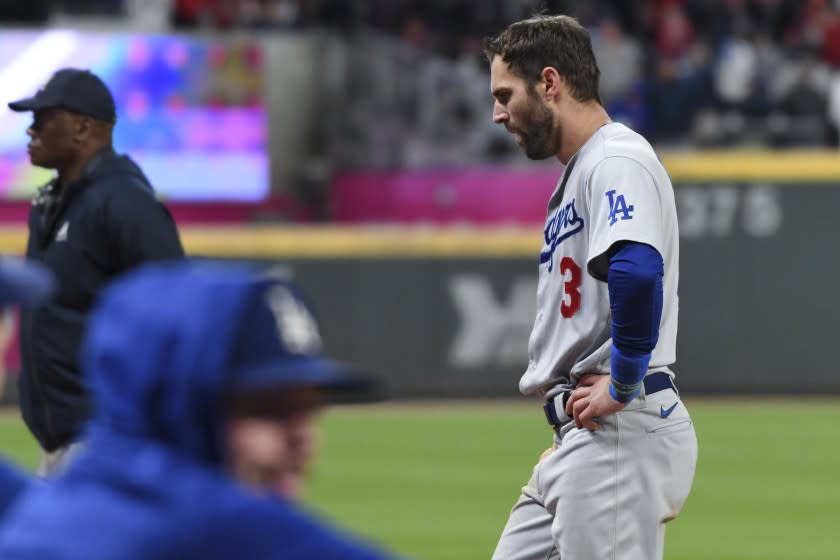 Atlanta, GA - October 16: Los Angeles Dodgers' Chris Taylor walks back to the dugout after being caught in a rundown.