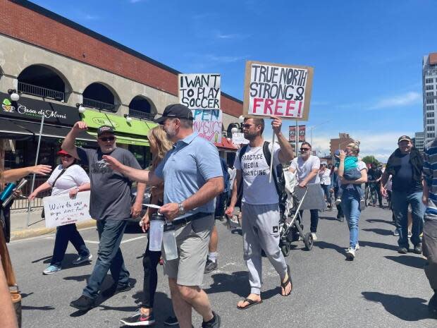 People march through the ByWard Market in downtown Ottawa during a rally against COVID-19 lockdown measures on May 15, 2021. ( Jeremie Bergeron/Radio-Canada - image credit)