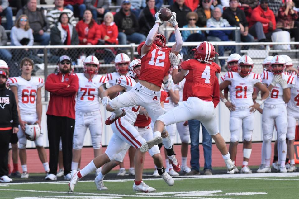 Albany's Cooper Fairchild (12) goes up for an interception against Muenster during the Region II-2A Division II semifinal.