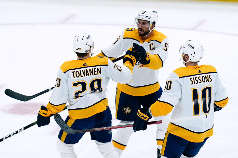 Nashville Predators right wing Eeli Tolvanen (28) celebrates his goal against the Arizona Coyotes with center Colton Sissons (10) and defenseman Roman Josi (59) during the first period of an NHL hockey game Friday, April 29, 2022, in Glendale, Ariz. (AP Photo/Ross D. Franklin)