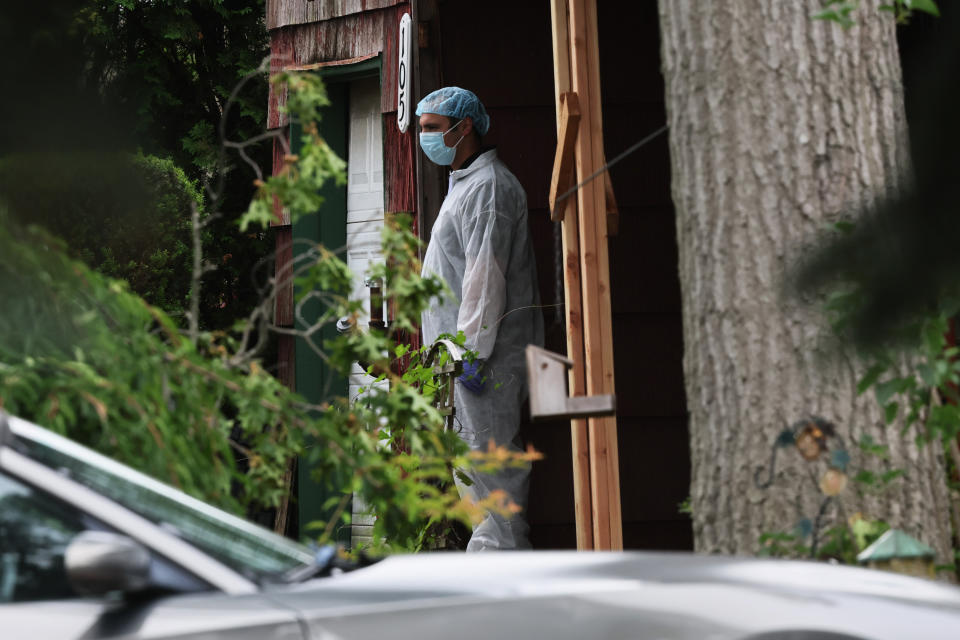 Law enforcement officials investigate the home of a suspect arrested in the Gilgo Beach killings on July 14, 2023 in Massapequa Park, N.Y. (Michael M. Santiago / Getty Images)
