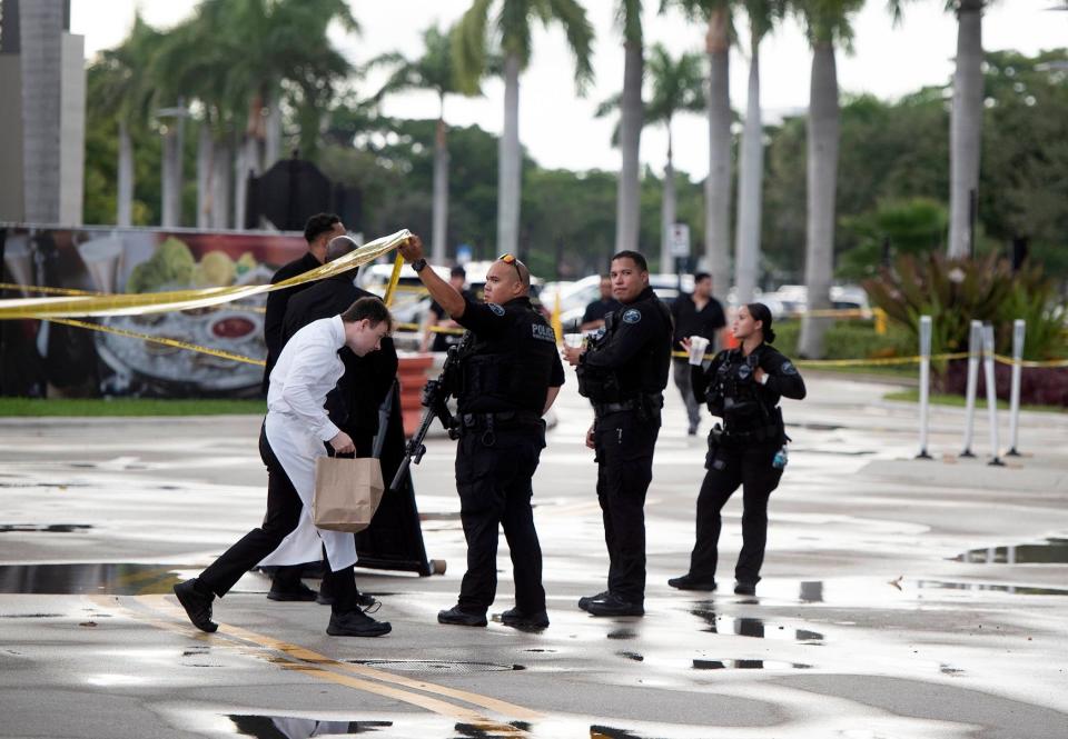 Boca Raton police help a person leave the Town Center Mall on Saturday evening after a "swatting" attempt on a Fortnite streamer led police to evacuate the shopping center.