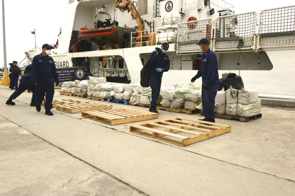 Crew members aboard the Coast Guard Cutter Vigilant stack seized cocaine at Coast Guard Base Miami Beach, Florida, in this photo taken June 12, 2015.  The crew of the Vigilant and the Coast Guard Cutter Bear interdicted the cocaine worth an estimated wholesale value of $10.9 million on May 22, 2015, according to a news release. Picture taken June 12, 2015.  REUTERS/U.S. Coast Guard/Petty Officer 3rd Class Mark Barney/Handout  THIS IMAGE HAS BEEN SUPPLIED BY A THIRD PARTY. IT IS DISTRIBUTED, EXACTLY AS RECEIVED BY REUTERS, AS A SERVICE TO CLIENTS. FOR EDITORIAL USE ONLY. NOT FOR SALE FOR MARKETING OR ADVERTISING CAMPAIGNS