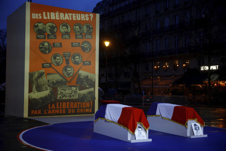 The coffins of Missak Manouchian and his wife Melinee Manouchian, covered with the French flag, placed in front of the Affiche Rouge (Red Poster) are seen before the induction ceremony for Missak Manouchian and his 23 resistance fighters into the Pantheon monument, Wednesday, Feb 21, 2024 in Paris. While France hosts grandiose ceremonies commemorating D-Day, Missak Manouchian and his Resistance fighters' heroic role in World War II are often overlooked. A poet who took refuge in France after surviving the Armenian genocide, Manouchian was executed in 1944 for leading the resistance to Nazi occupation. (Sarah Meyssonnier/Pool via AP)