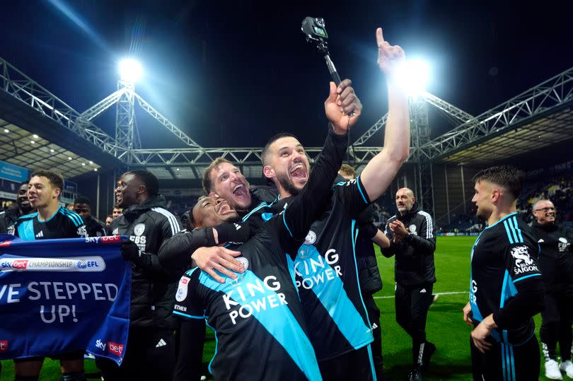 Abdul Fatawu, Marc Albrighton, and Conor Coady celebrate after Leicester City clinched the Championship title with a 3-0 win over Preston