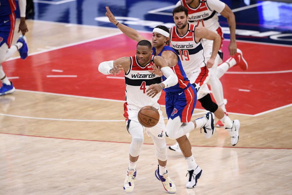 Washington Wizards guard Russell Westbrook (4) is fouled by Detroit Pistons guard Frank Jackson, right, during the first half of an NBA basketball game, Saturday, April 17, 2021, in Washington. Also seen is Wizards guard Raul Neto (19). (AP Photo/Nick Wass)