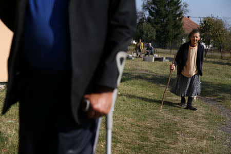 Bosnian Serb Zorica Tomic (R), an internally displaced person, walks in front of a reception center Kladari Donji where IDPs live, near Modrica, Bosnia and Herzegovina, October 1, 2018. REUTERS/Dado Ruvic