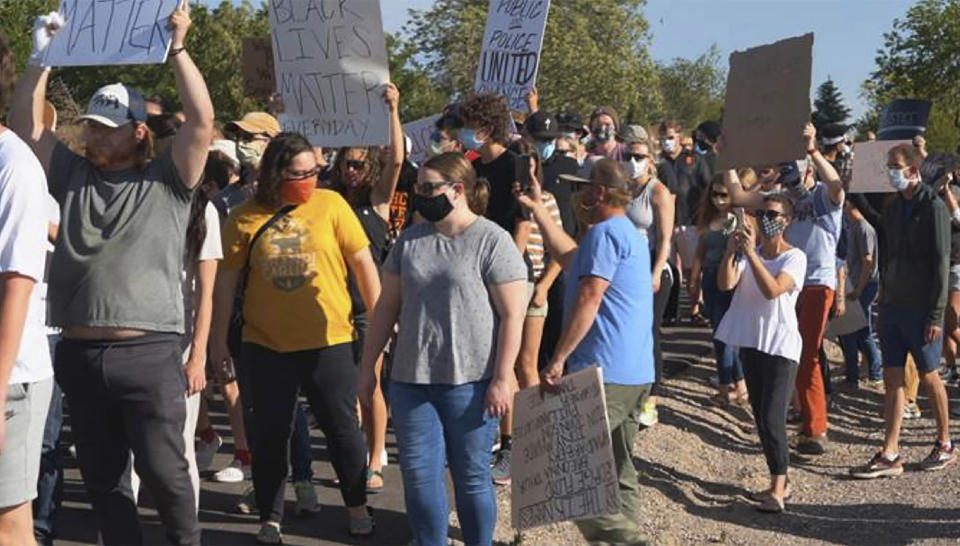 In this June 3, 2020, photo provided by Idaho State Athletics, people walk during a unity march, in Pocatello, Idaho. A strong connection between law enforcement and Idaho State student-athletes set the stage for the peaceful unity march. (Jarius Fields/Idaho State Athletics via AP)