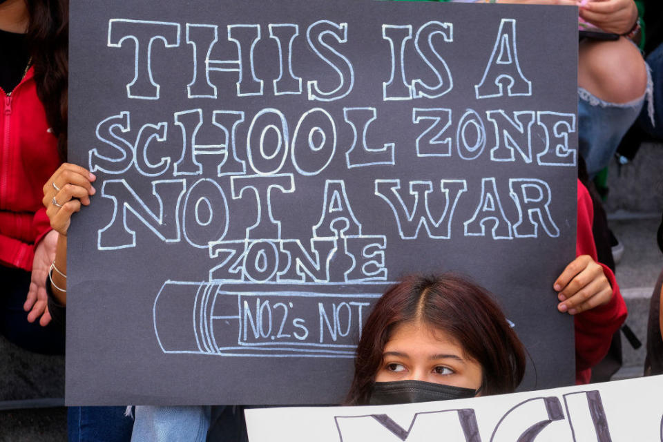 a sign that says this is a school zone not a war zone