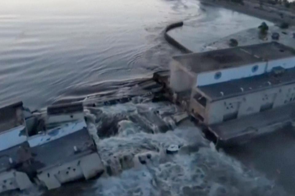 floodwaters rush over buildings